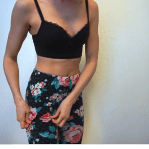 woman wearing black bra and flower leggings doing a panty try on